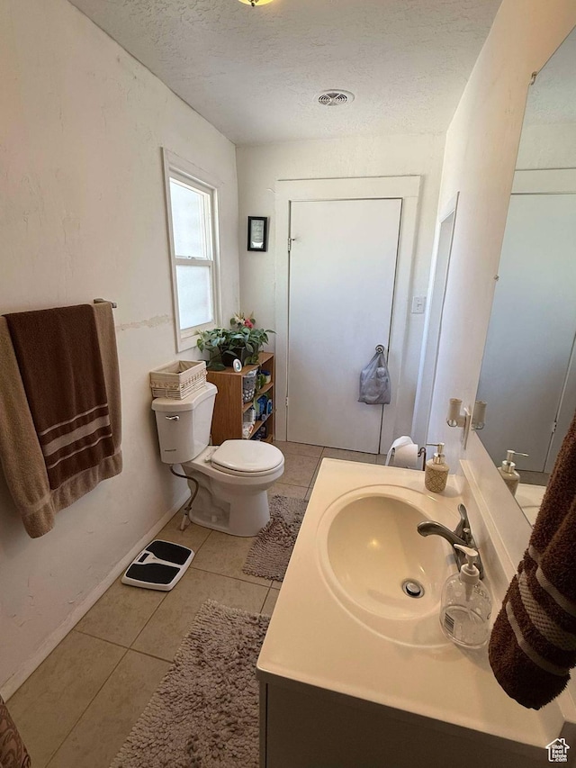 3274 W 3100 S, West Valley City, UT 84119 - bathroom featuring tile patterned floors, toilet, vanity, and a textured ceiling