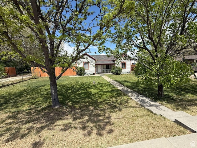 3274 W 3100 S, West Valley City, UT 84119 - view of front of home with fence and a front lawn