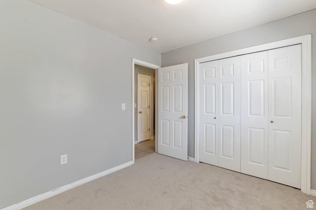 770 N Quincy Ave, Ogden, UT 84404 - unfurnished bedroom with baseboards, light carpet, and a closet