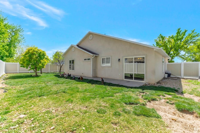 770 N Quincy Ave, Ogden, UT 84404 - rear view of house with a lawn, stucco siding, a fenced backyard, and a patio