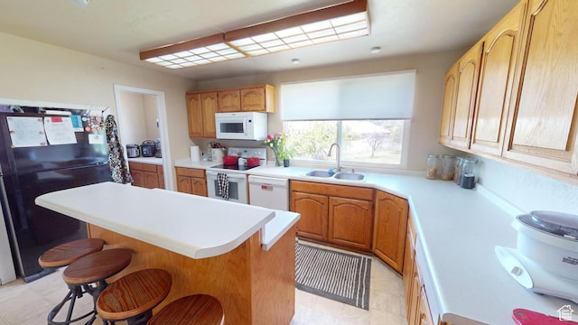 983 E Antelope Dr N, Layton, UT 84040 - kitchen featuring white appliances, a sink, a kitchen bar, and light countertops