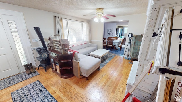 983 E Antelope Dr N, Layton, UT 84040 - living room featuring wood finished floors, a ceiling fan, and a textured ceiling