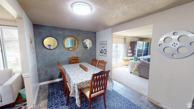 983 E Antelope Dr N, Layton, UT 84040 - carpeted dining area featuring a textured ceiling, baseboards, and an accent wall