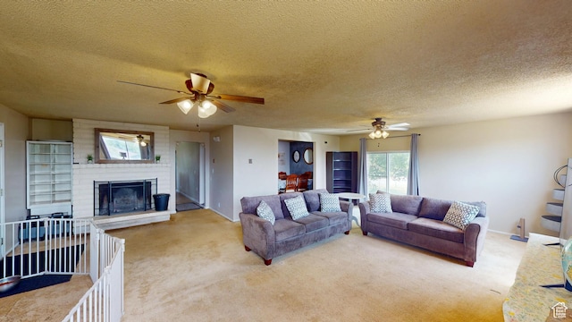 983 E Antelope Dr N, Layton, UT 84040 - carpeted living room featuring ceiling fan, a fireplace, and a textured ceiling