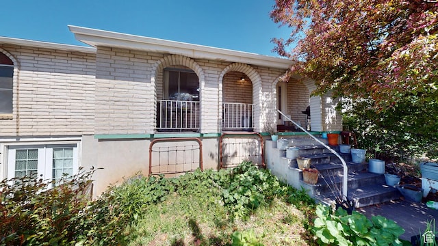 983 E Antelope Dr N, Layton, UT 84040 - view of front facade with a porch and brick siding