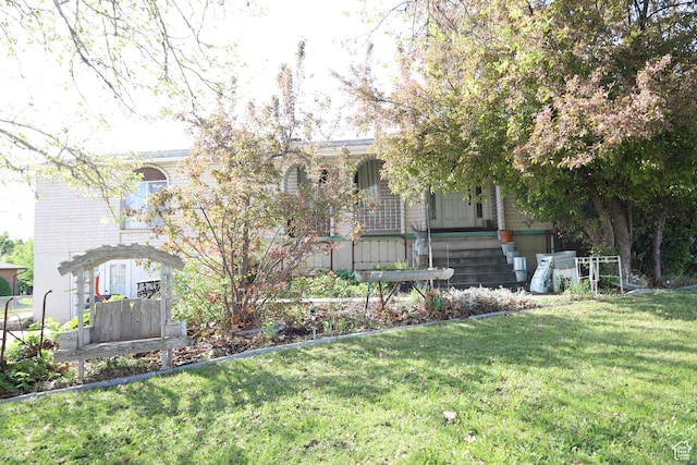 983 E Antelope Dr N, Layton, UT 84040 - obstructed view of property featuring a front yard and covered porch