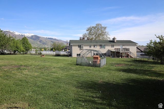 983 E Antelope Dr N, Layton, UT 84040 - back of property featuring stairway, a chimney, and a deck with mountain view