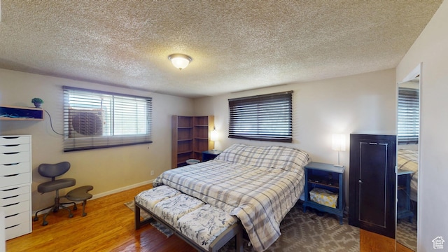 983 E Antelope Dr N, Layton, UT 84040 - bedroom featuring wood finished floors and a textured ceiling