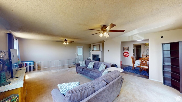 983 E Antelope Dr N, Layton, UT 84040 - living area featuring light colored carpet, a ceiling fan, a textured ceiling, and a large fireplace