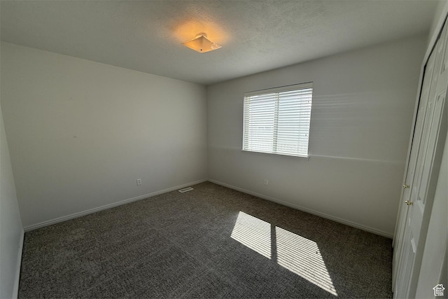 166 E Cove Rd, Saratoga Springs, UT 84045 - spare room featuring dark colored carpet and baseboards