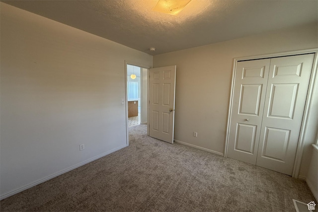 166 E Cove Rd, Saratoga Springs, UT 84045 - unfurnished bedroom featuring carpet flooring, a textured ceiling, a closet, and baseboards
