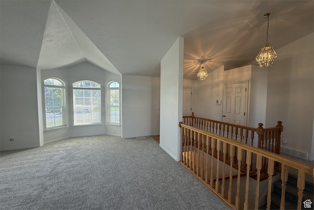 166 E Cove Rd, Saratoga Springs, UT 84045 - spare room featuring a chandelier, vaulted ceiling, baseboards, and carpet floors