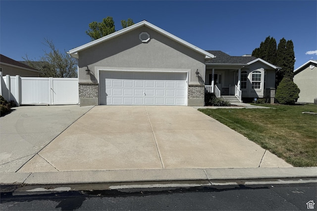 166 E Cove Rd, Saratoga Springs, UT 84045 - ranch-style house with driveway, covered porch, an attached garage, stucco siding, and brick siding