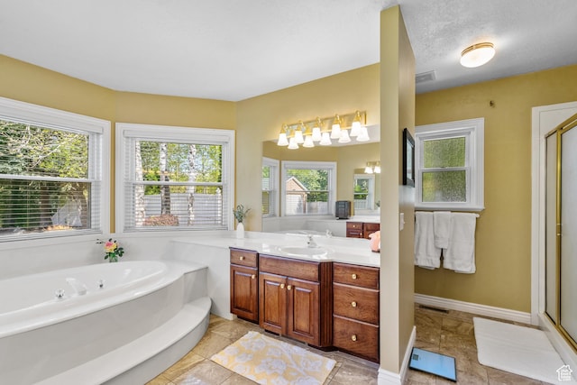 bathroom with vanity, a shower stall, a bath, and visible vents
