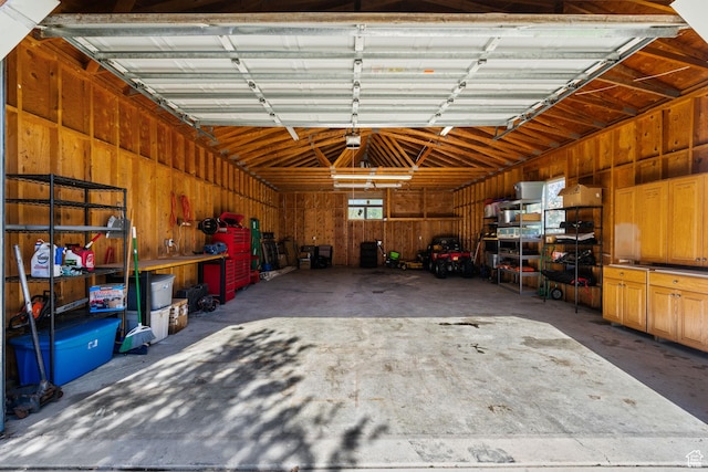 garage featuring wood walls
