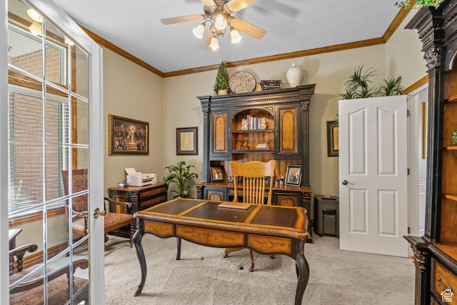 office area featuring ceiling fan, light carpet, and crown molding
