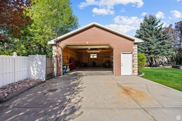 detached garage featuring fence