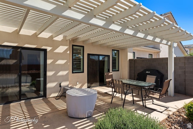view of patio featuring a pergola, outdoor dining area, and fence
