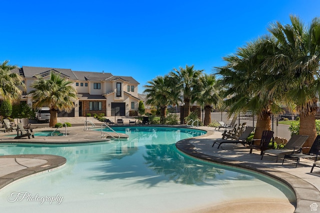 pool featuring a patio and fence