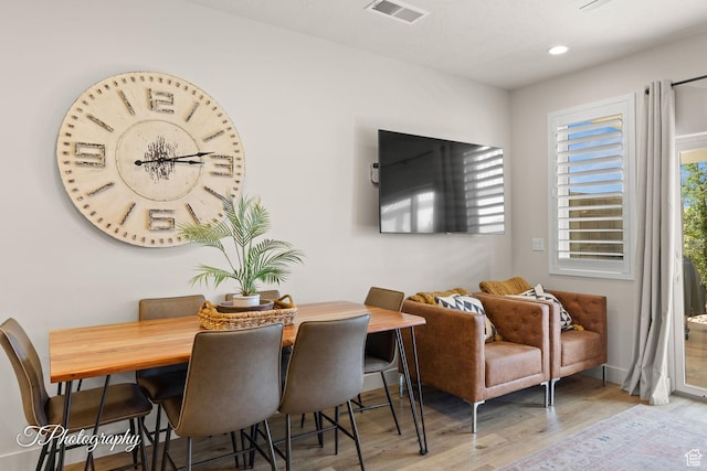 dining room with recessed lighting, visible vents, and wood finished floors