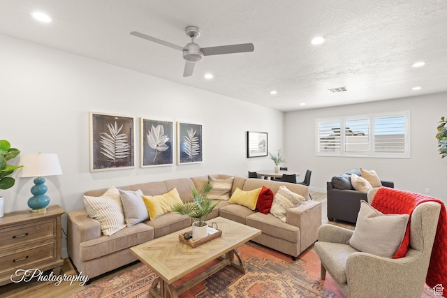 living area featuring a ceiling fan, recessed lighting, visible vents, and wood finished floors