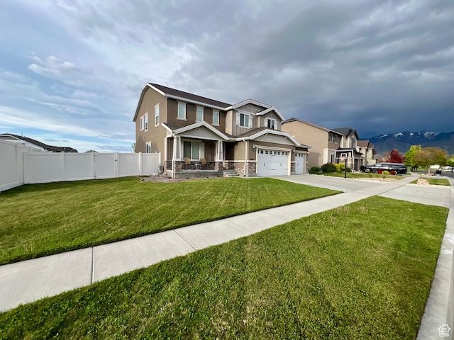 642 W Mulberry St, Stansbury Park, UT 84074 - craftsman house featuring stucco siding, fence, a front lawn, a porch, and driveway
