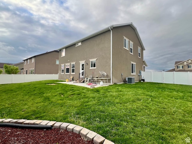 642 W Mulberry St, Stansbury Park, UT 84074 - back of property with a fenced backyard, a patio, stucco siding, and a lawn