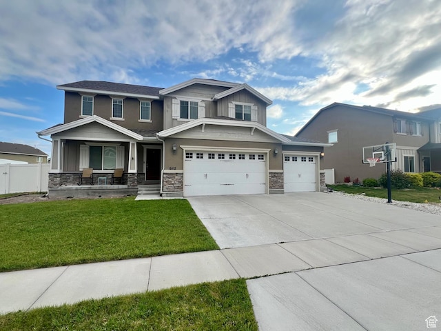 642 W Mulberry St, Stansbury Park, UT 84074 - craftsman inspired home featuring a porch, driveway, stone siding, and a front yard