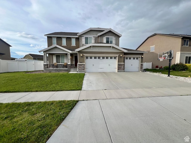 642 W Mulberry St, Stansbury Park, UT 84074 - craftsman-style home with driveway, a front yard, fence, an attached garage, and stone siding