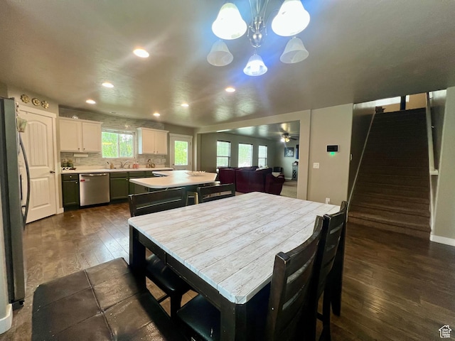 642 W Mulberry St, Stansbury Park, UT 84074 - dining space with recessed lighting, baseboards, ceiling fan with notable chandelier, stairway, and dark wood-style floors