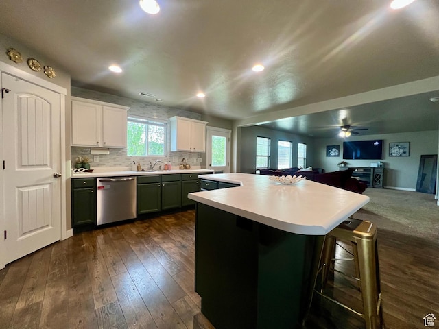 642 W Mulberry St, Stansbury Park, UT 84074 - kitchen with dark wood-style flooring, a kitchen breakfast bar, light countertops, and dishwasher