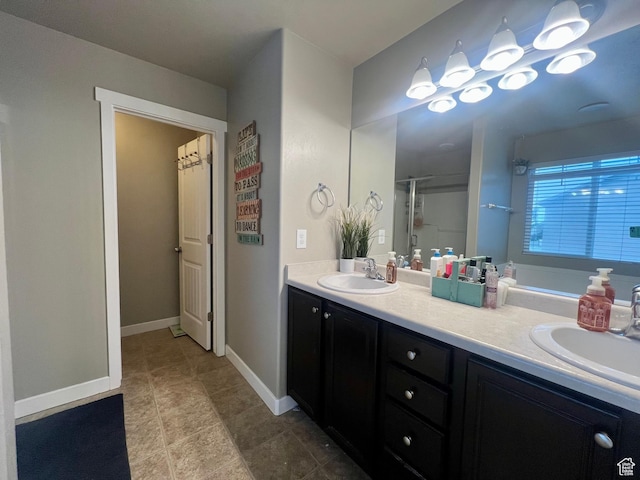 642 W Mulberry St, Stansbury Park, UT 84074 - bathroom featuring a shower with shower door, baseboards, double vanity, and a sink