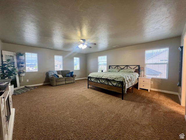 642 W Mulberry St, Stansbury Park, UT 84074 - bedroom featuring baseboards, a ceiling fan, and dark carpet