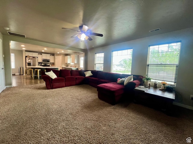 642 W Mulberry St, Stansbury Park, UT 84074 - living area with carpet, visible vents, baseboards, and ceiling fan