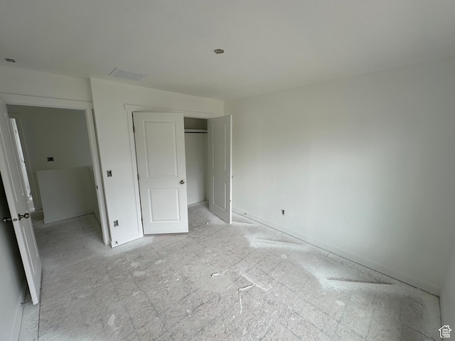 unfurnished bedroom featuring a closet and visible vents
