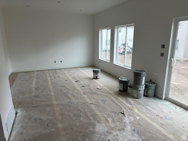 unfurnished living room with a wealth of natural light and visible vents