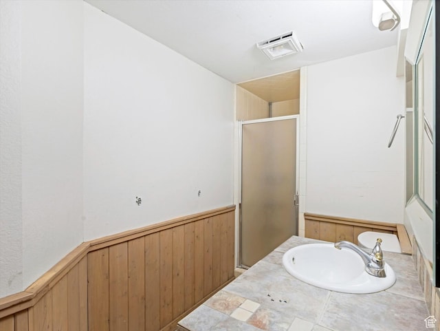 601 E Valley Dr, Heber City, UT 84032 - full bathroom featuring a stall shower, visible vents, a sink, wooden walls, and a wainscoted wall