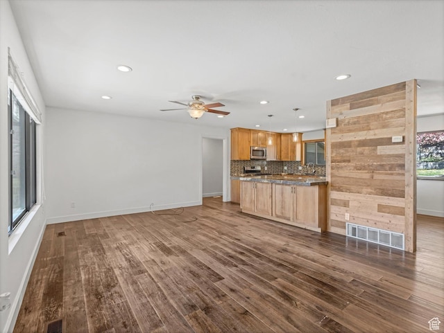 601 E Valley Dr, Heber City, UT 84032 - kitchen with dark wood-style flooring, decorative backsplash, visible vents, and stainless steel microwave