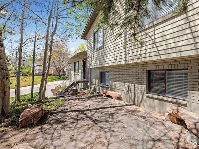 601 E Valley Dr, Heber City, UT 84032 - view of home's exterior featuring brick siding and a patio