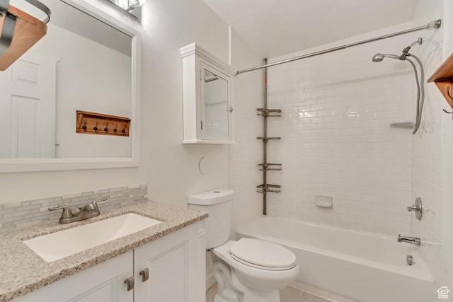 bathroom featuring toilet, vanity, shower / bathing tub combination, and tasteful backsplash