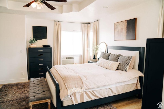 290 W 300 N, Beaver, UT 84713 - bedroom with wood finished floors, baseboards, ceiling fan, and a wall mounted air conditioner