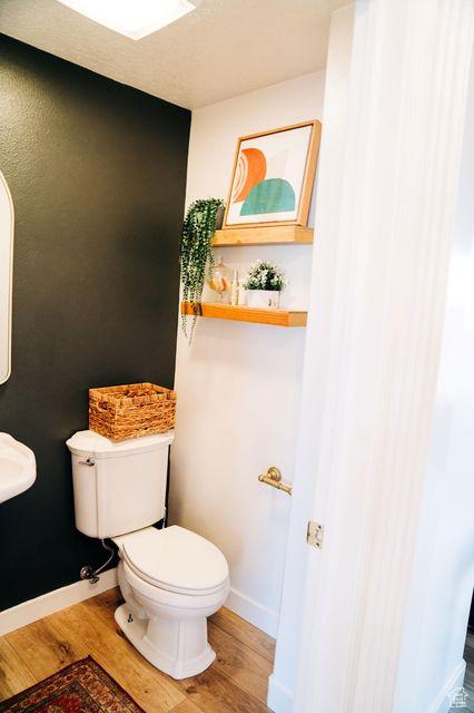 290 W 300 N, Beaver, UT 84713 - half bathroom featuring wood finished floors, toilet, and baseboards