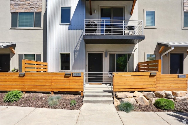 2237 N 450 W, Layton, UT 84041 - view of front of home featuring a balcony, stucco siding, and fence