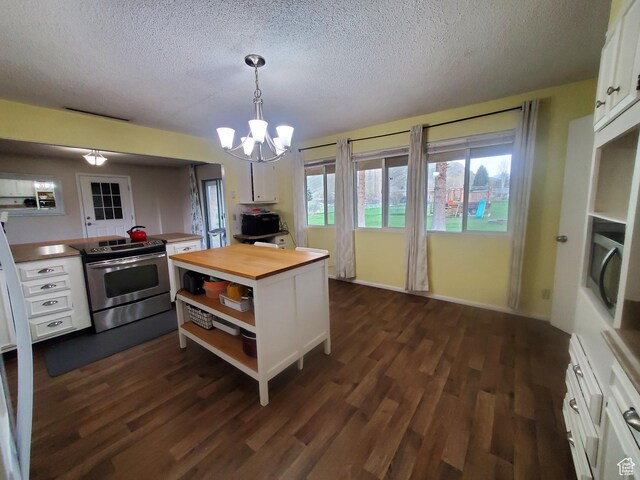 350 N 3rd St, Montpelier, ID 83254 - kitchen featuring electric range, butcher block countertops, white cabinets, a textured ceiling, and open shelves
