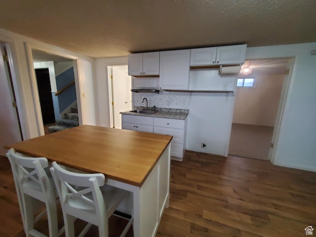 350 N 3rd St, Montpelier, ID 83254 - kitchen with a sink, white cabinetry, dark wood finished floors, butcher block counters, and tasteful backsplash