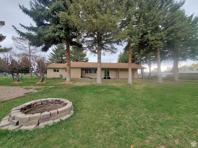 350 N 3rd St, Montpelier, ID 83254 - back of house featuring an outdoor fire pit and a yard