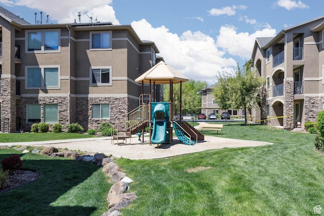 community jungle gym with a yard