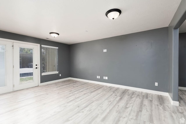 unfurnished room featuring baseboards and wood finished floors