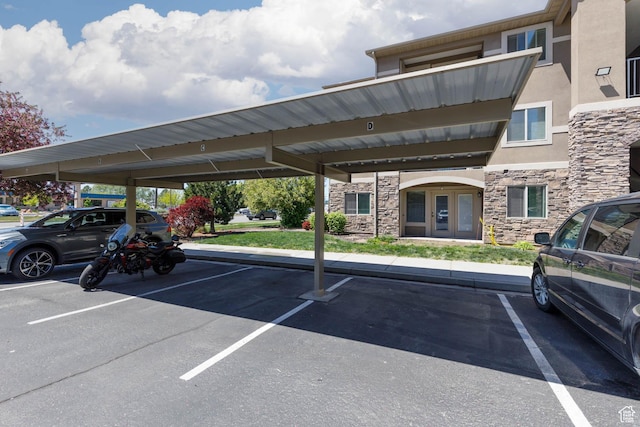 covered parking lot featuring french doors