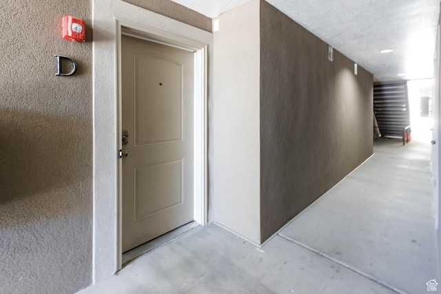 entrance to property featuring stucco siding